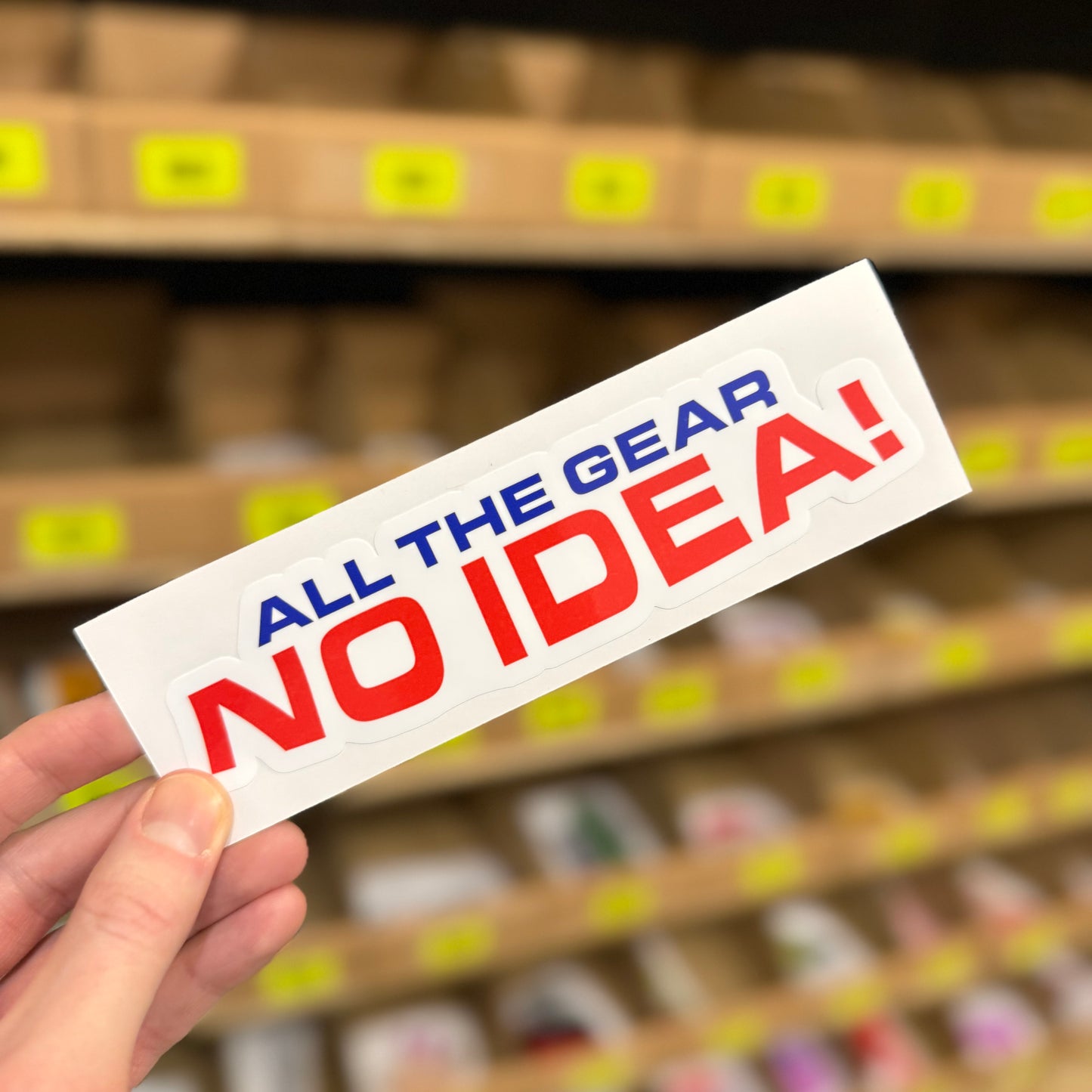 Funny motorbike and cycling slogan sticker reading “All the gear no idea”