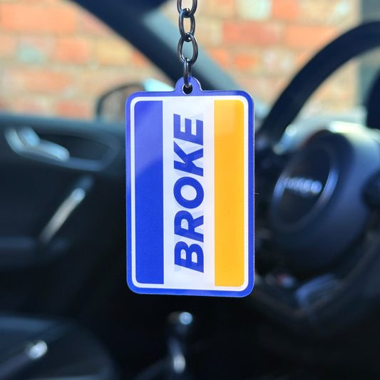 Funny “Broke” keychain with blue and yellow sign-style design, durable acrylic keyring for car enthusiasts, novelty automotive accessory made in the UK
