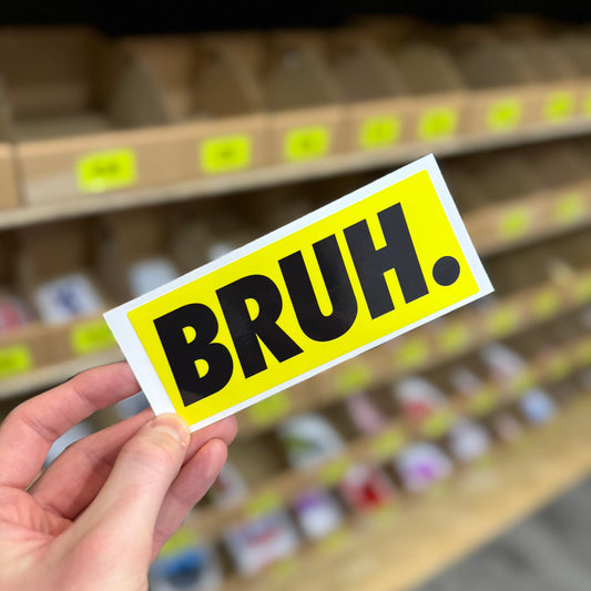 Funny slang sticker reading “bruh” in bold black text on yellow background
