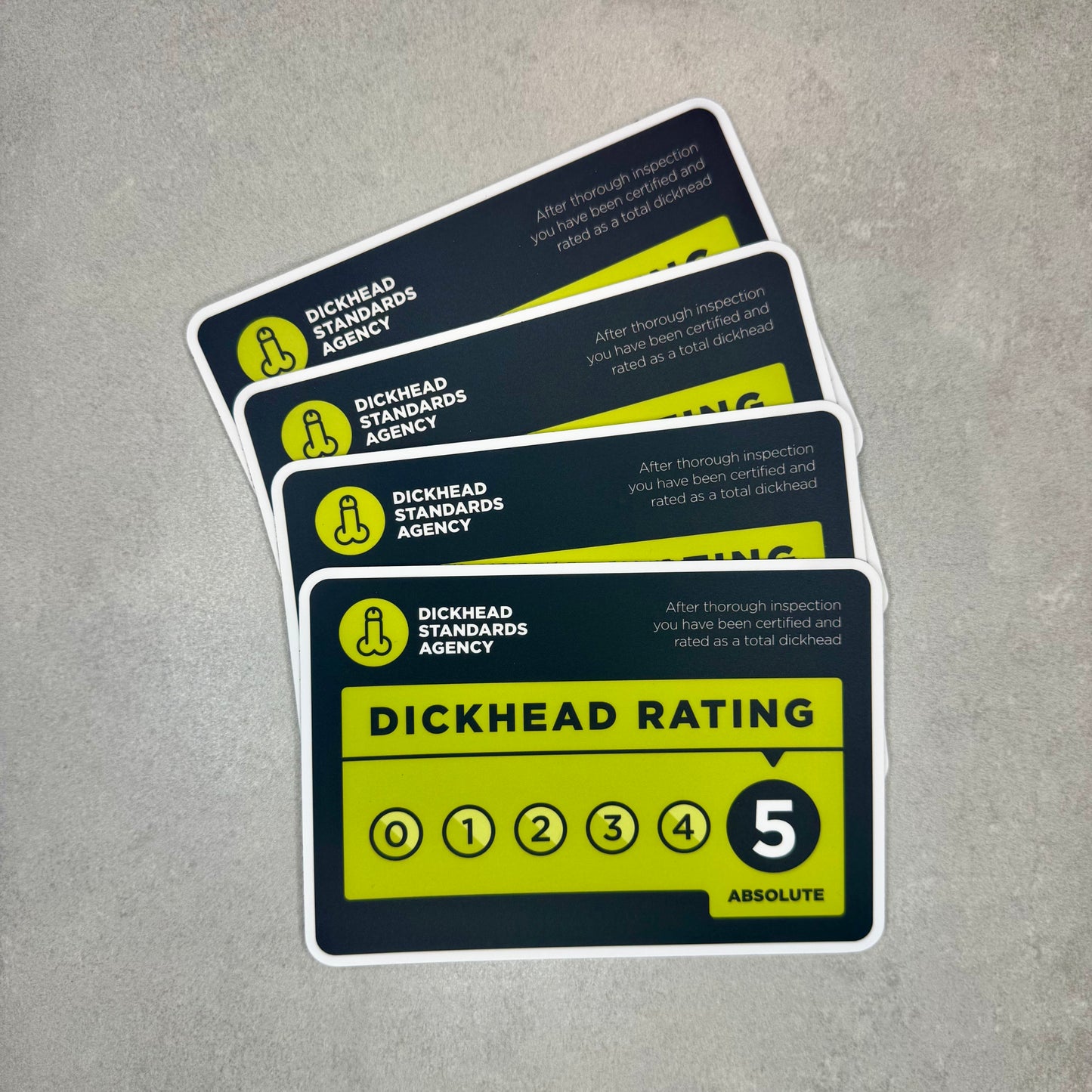 Dickhead Rating funny magnet stack showing novelty inspection style design with rating scale. Removable fridge or toolbox magnet made with durable 0.8mm magnetic sheeting and matte laminate finish by Blum Decals UK.