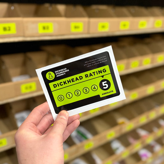 Parody inspection label “Dickhead rating” funny vinyl sticker with scale graphic.