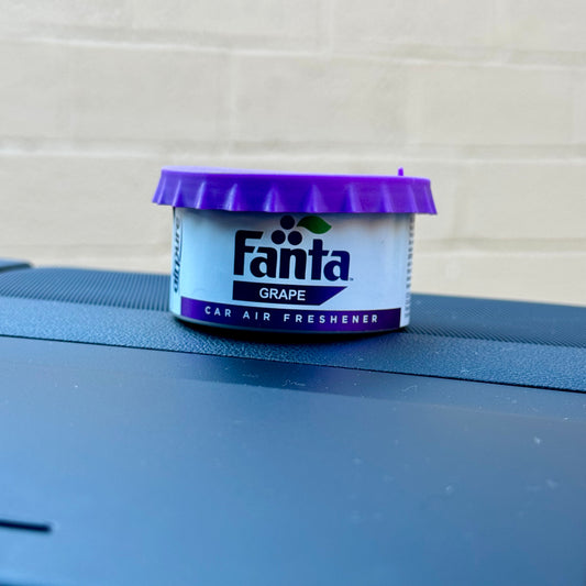 Fanta Grape Twist Tin Car Air Freshener on Car Dashboard
