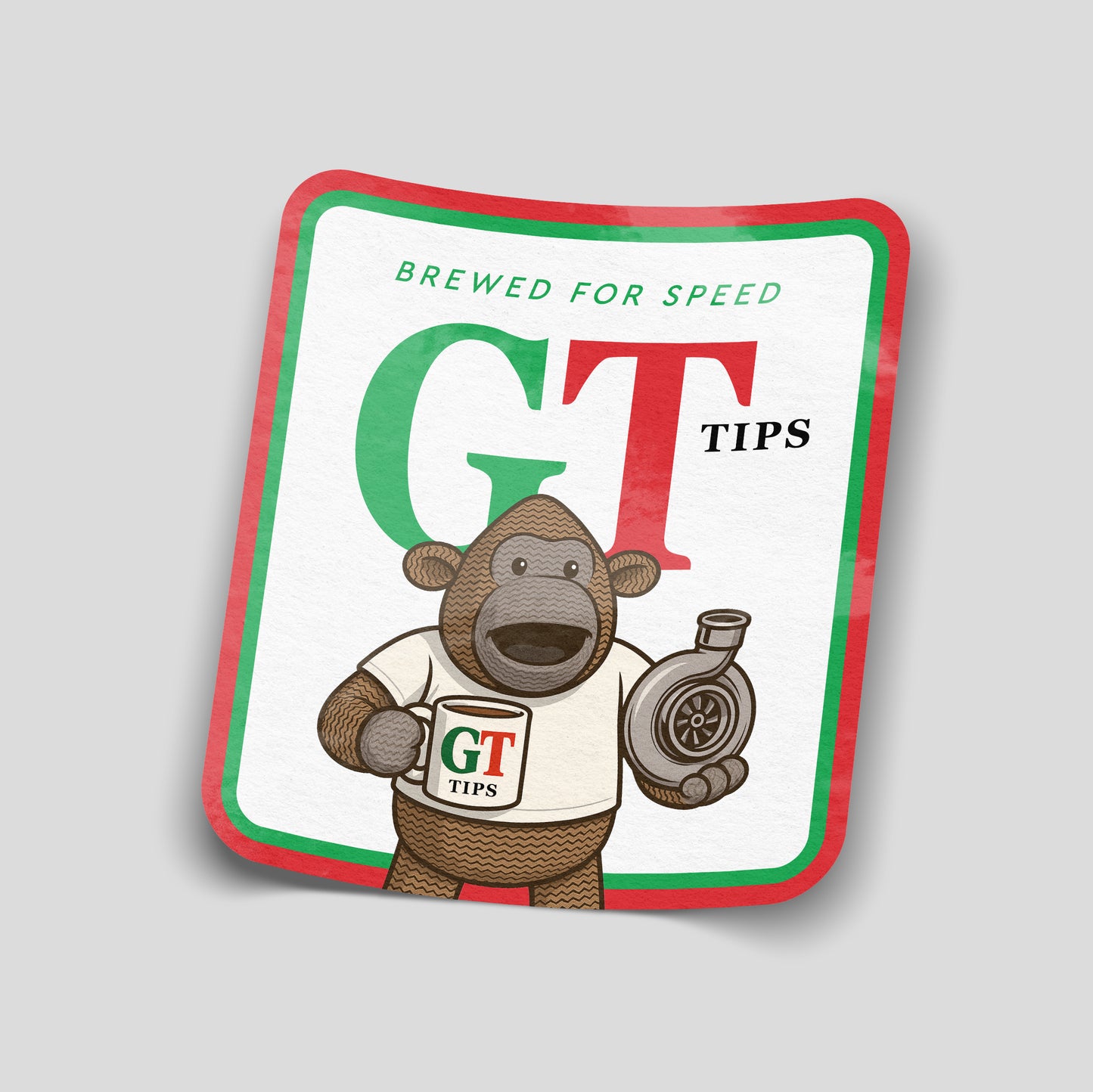 GT Tips funny car sticker featuring a cartoon monkey holding a turbo and a mug, green and red branding style, UK automotive humour decal.