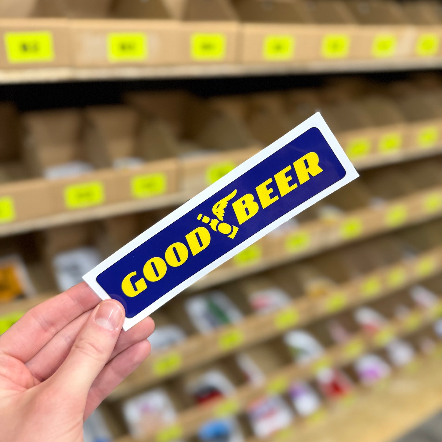 Funny beer sticker reading “good beer” with winged bottle graphic