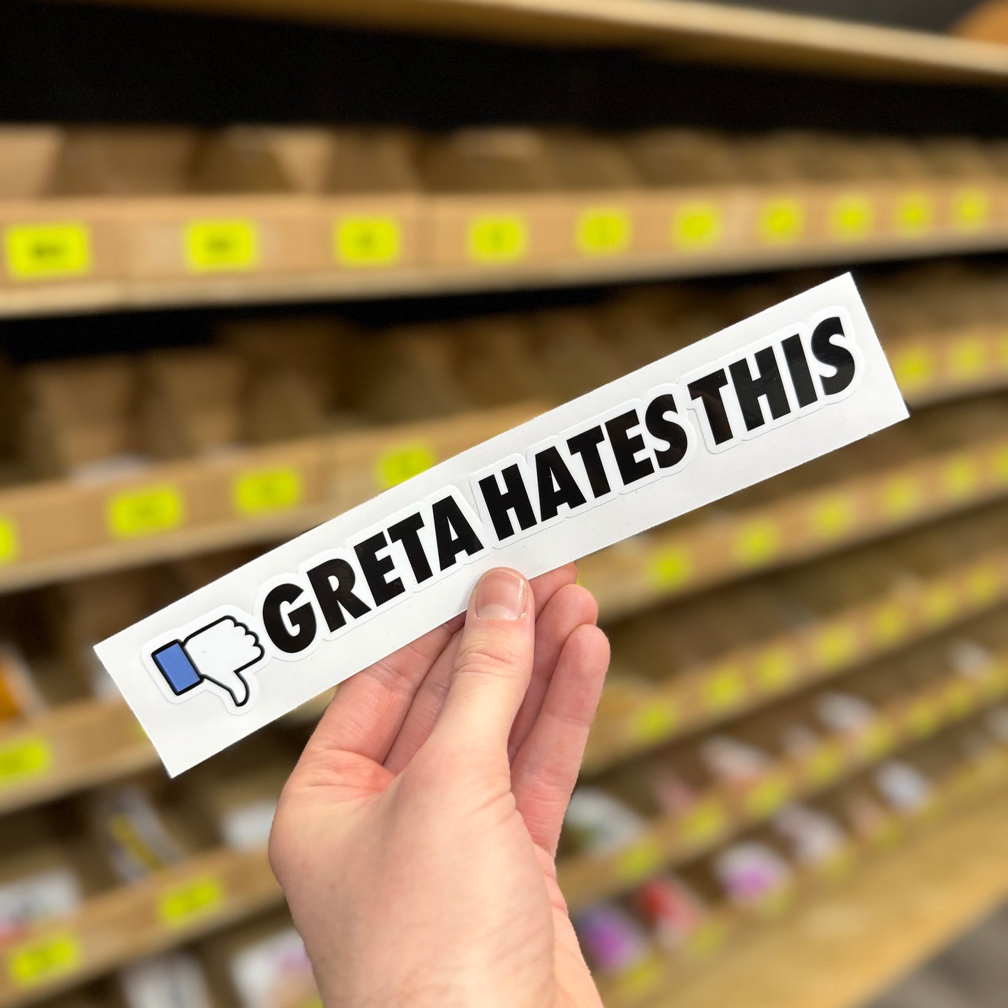 Funny car sticker reading “Greta hates this” with thumbs down icon