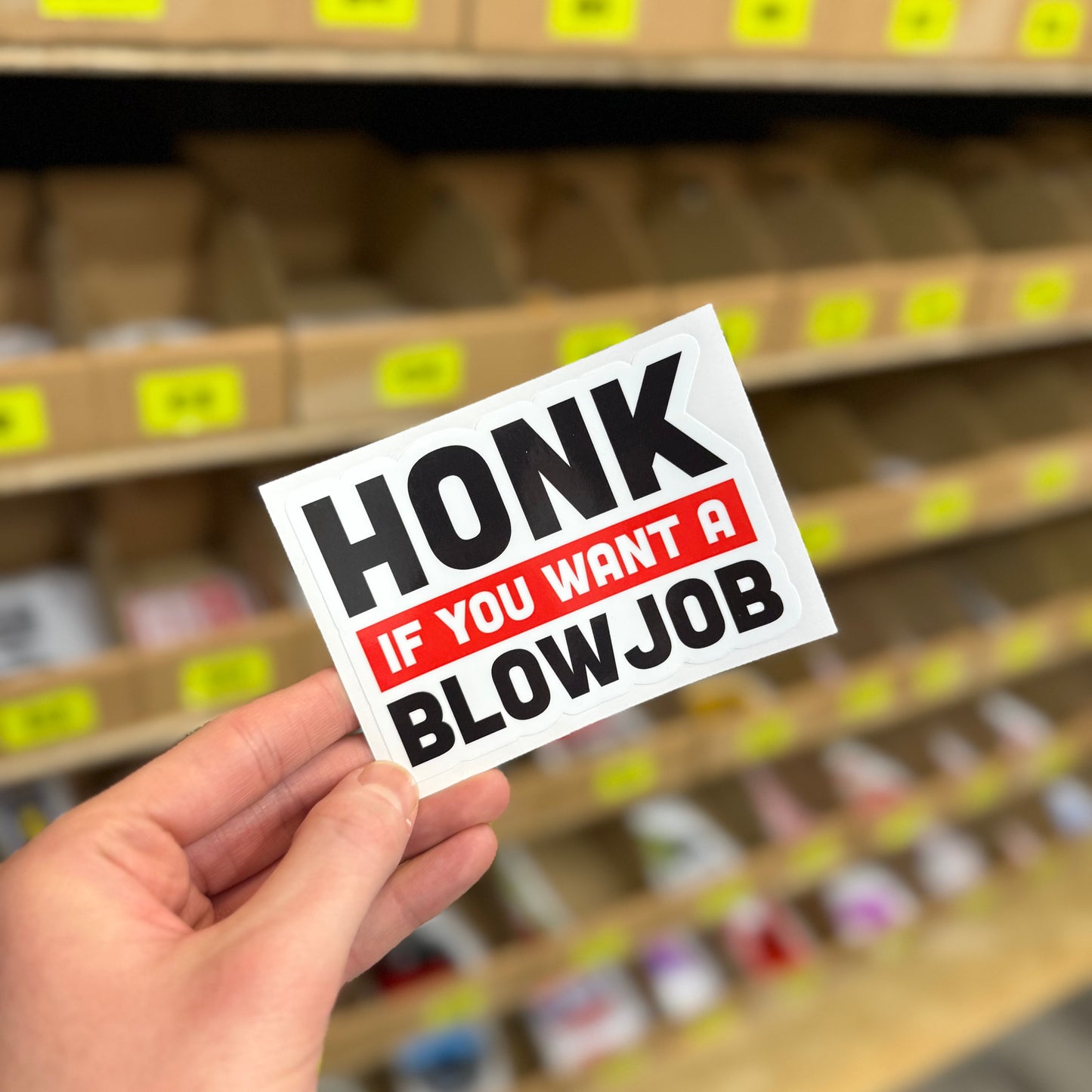 Funny rude car sticker reading “honk if you want a blowjob” bold block text design
