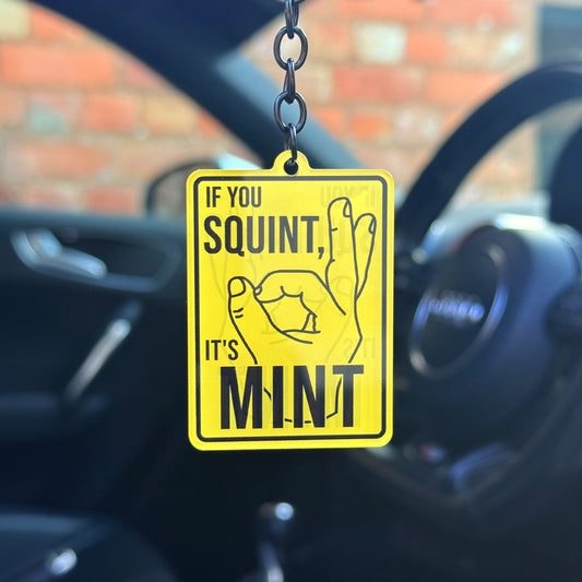 Funny “If you squint, it’s mint” keychain with bold yellow sign design, novelty car humour keyring for modified cars and projects, UK made acrylic