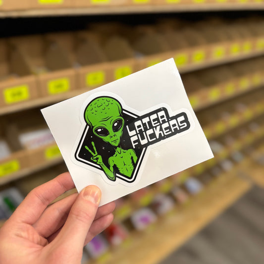 Funny alien sticker showing green alien flashing peace sign with “later fuckers” text