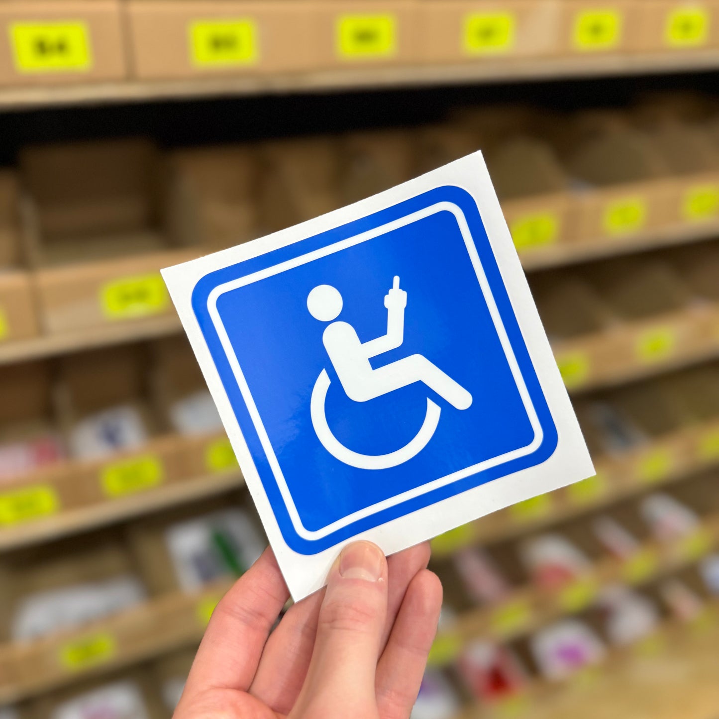 Funny rude sticker showing disabled symbol giving middle finger gesture