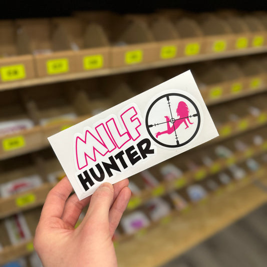 Funny rude sticker showing pink silhouette inside target crosshair with “milf hunter” text