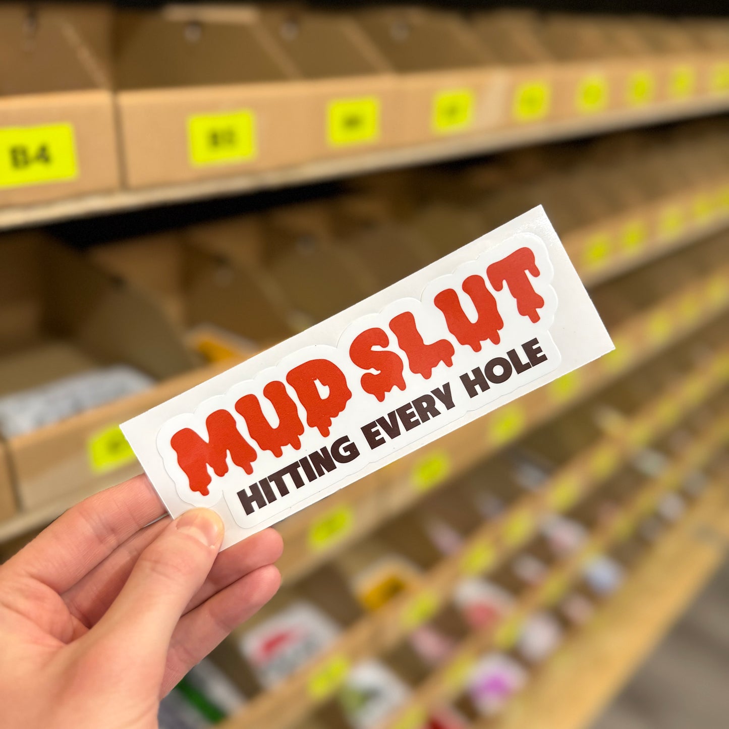 Funny rude off road sticker reading “mud slut hitting every hole” dripping red text