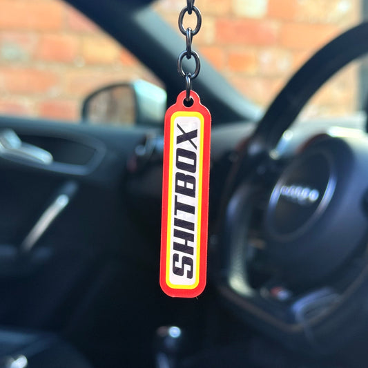 Funny “Shitbox” keychain with bold red tag-style design, novelty car humour keyring for project cars and daily drivers, UK made acrylic