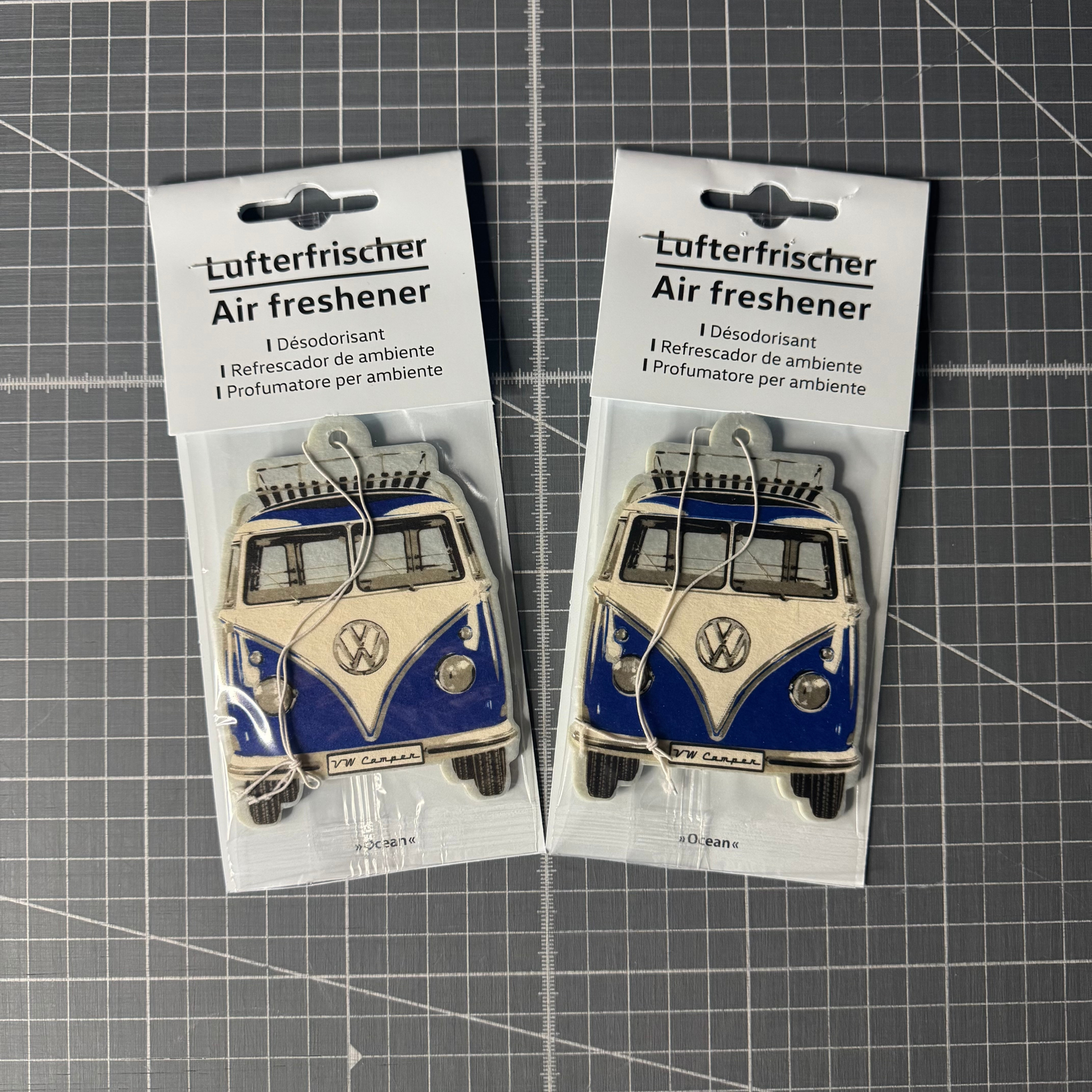 Packaged Volkswagen T1 Camper Van air freshener in fresh ocean scent. Officially licensed VW product with a retro camper van design, perfect for car interiors.