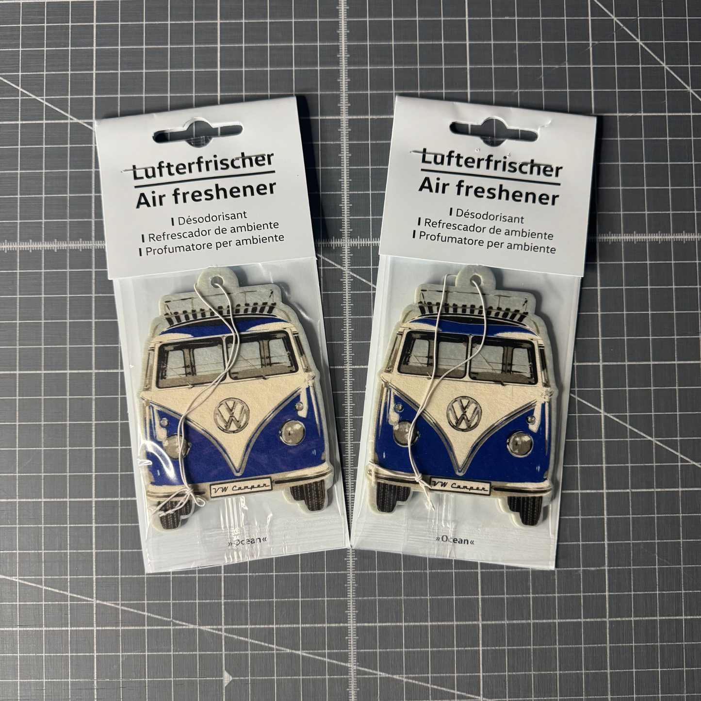 Packaged Volkswagen T1 Camper Van air freshener in fresh ocean scent. Officially licensed VW product with a retro camper van design, perfect for car interiors.