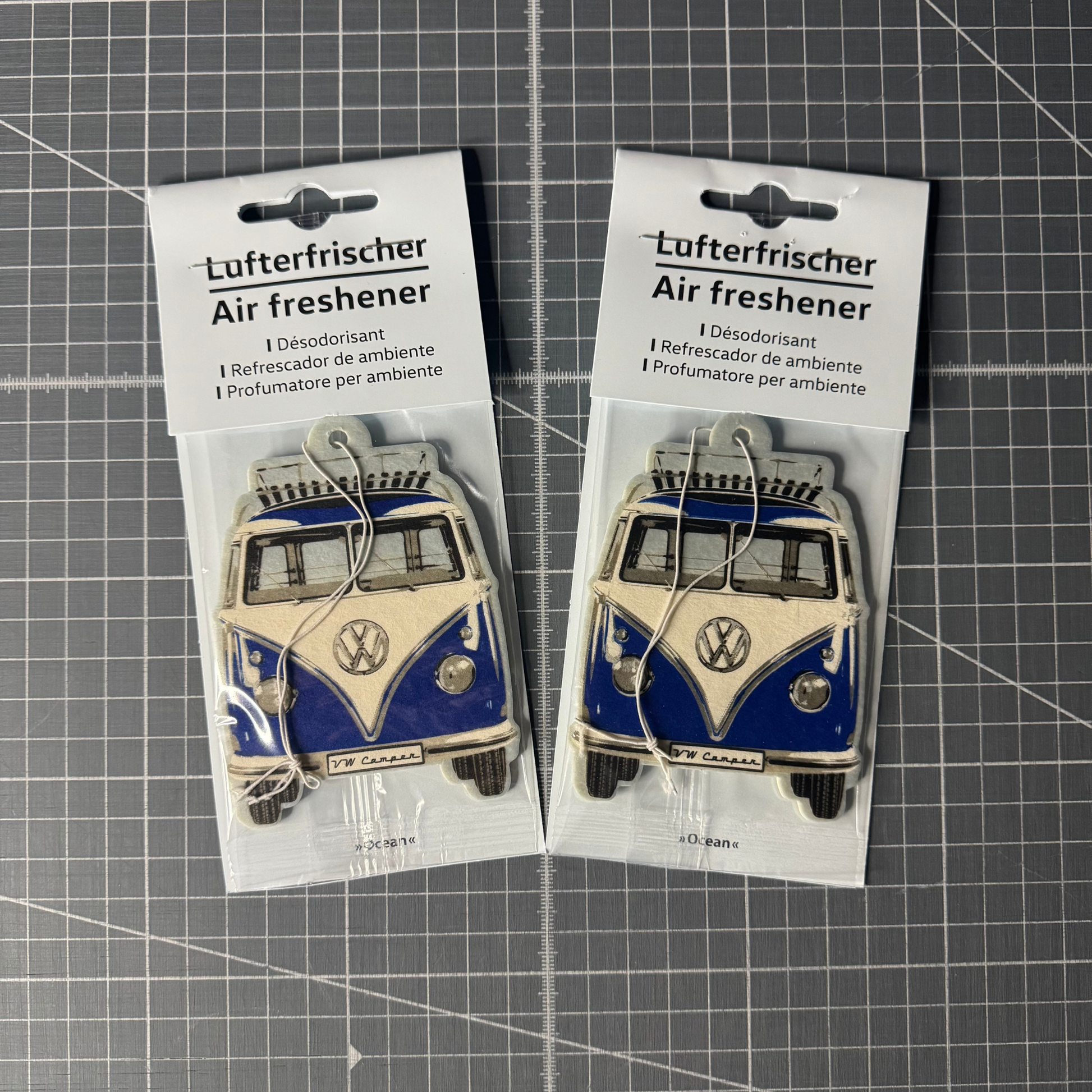 Packaged Volkswagen T1 Camper Van air freshener in fresh ocean scent. Officially licensed VW product with a retro camper van design, perfect for car interiors.