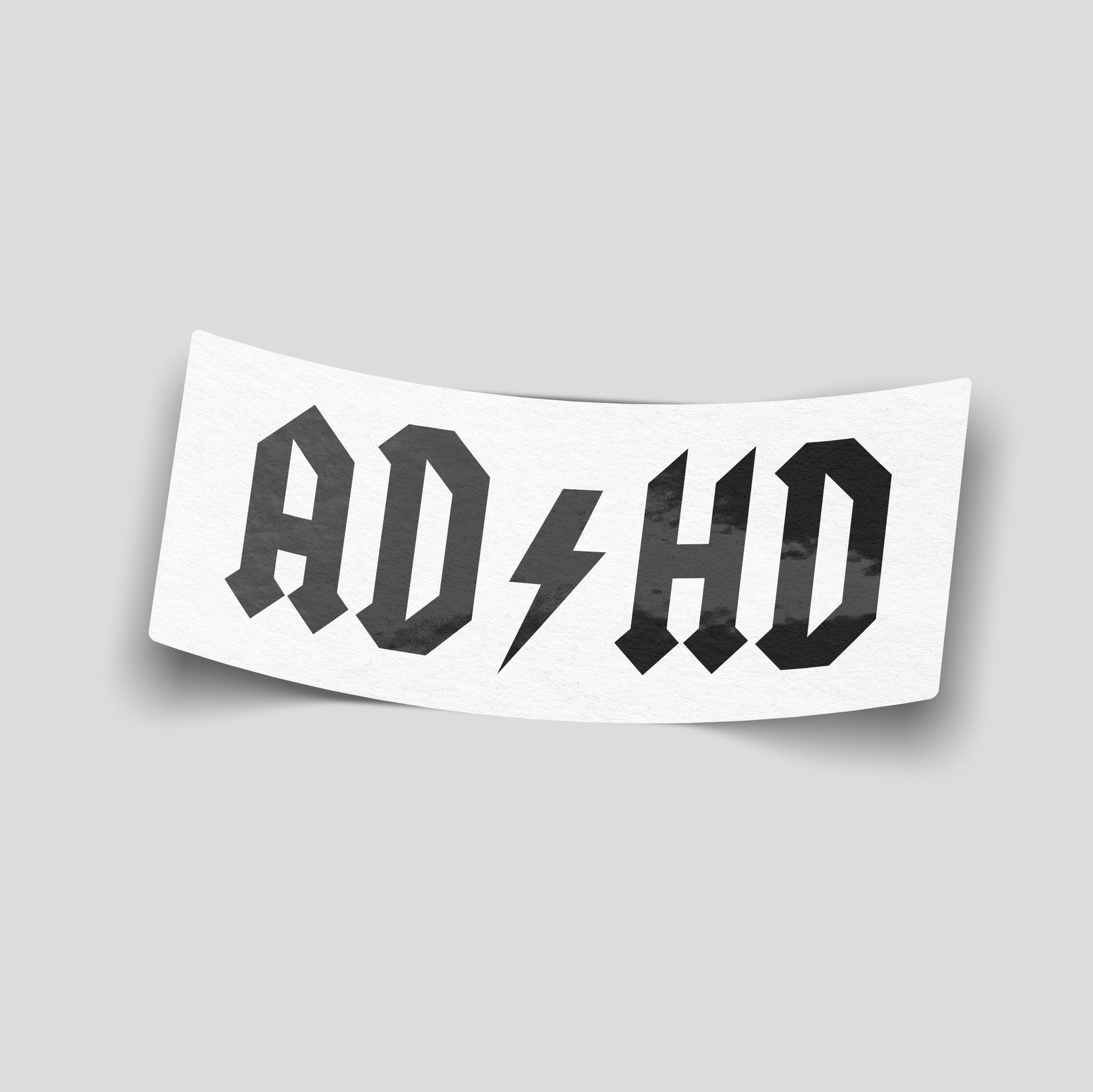 Black rock‑style “AD⚡HD” funny car sticker with lightning bolt graphic, UK novelty motoring decal.