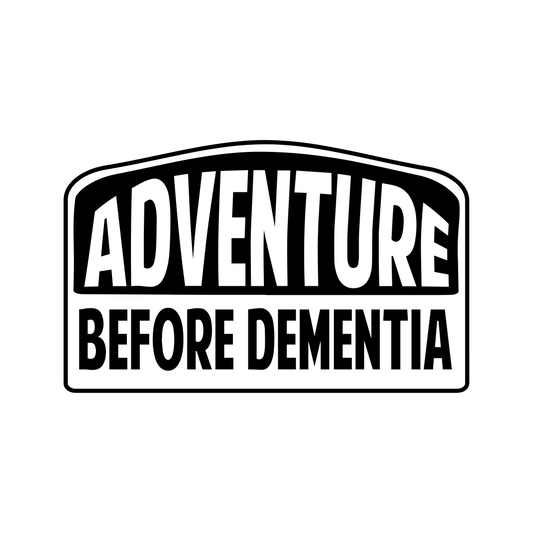 Black vinyl decal reading “Adventure Before Dementia” in bold lettering, sized 20cm x 12.5cm, suitable for vehicles or travel gear.