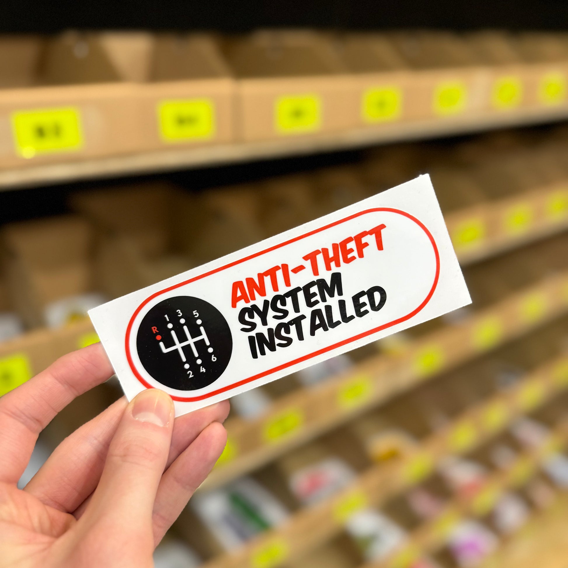 Manual gear shift graphic “Anti-theft system installed” funny vinyl sticker.