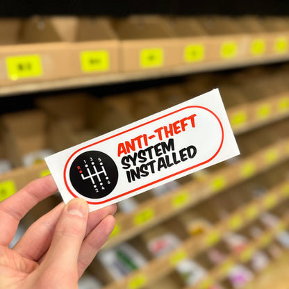 Manual gear shift graphic “Anti-theft system installed” funny vinyl sticker.