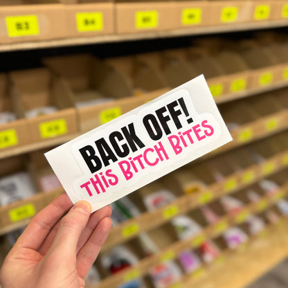 Funny warning sticker reading “Back off this bitch bites” in bold novelty text