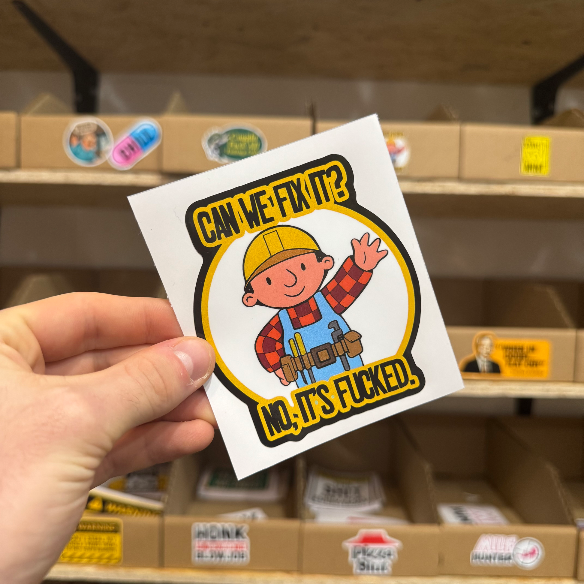 Funny cartoon builder sticker featuring a smiling construction worker in a hard hat with the text ‘Can we fix it? No, it’s f*cked.’