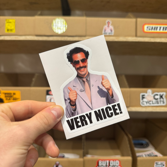 Humorous sticker of a man in a light grey suit giving two thumbs up with the bold caption ‘Very Nice!’ underneath.