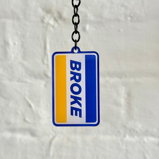 Funny “Broke” acrylic keychain with bold blue and yellow design, glossy double-sided print and black chain, perfect novelty car keyring for everyday drivers.
