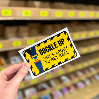 Funny warning sticker reading “buckle up shit’s about to get real” novelty decal