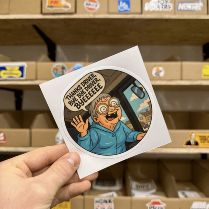 Cartoon-style round sticker showing an excited elderly person waving from the doorway of a bus, saying ‘Thanks driver, bye bye driver, byeeeee.’