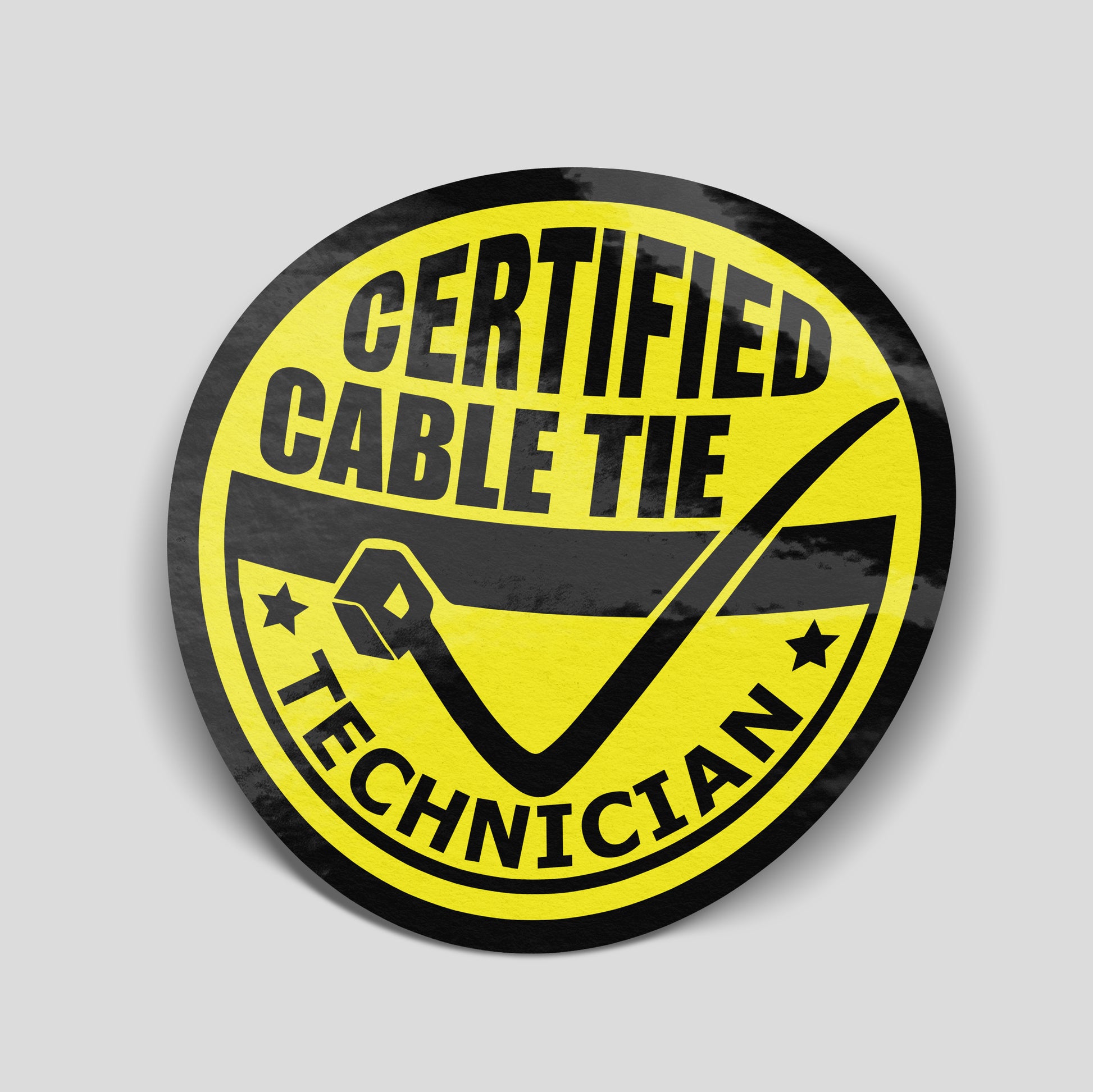 Round yellow and black “Certified Cable Tie Technician” funny car sticker with cable tie graphic, UK motoring humour decal.