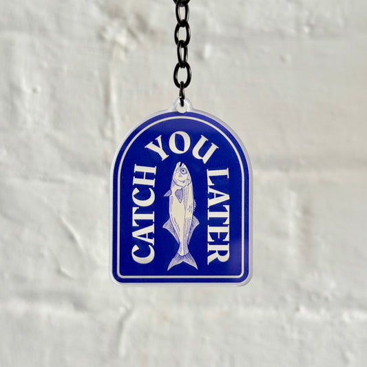 Funny “Catch You Later” acrylic keychain with blue fishing badge design, glossy double-sided print and black chain, perfect gift for fishing and car lovers.