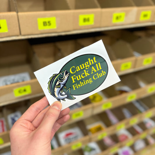 Funny fishing sticker with fish illustration and “caught fuck all fishing club” slogan