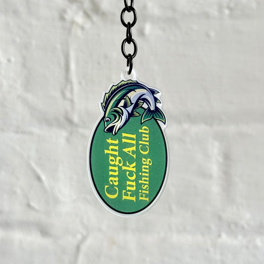 Funny “Caught F*ck All Fishing Club” acrylic keychain with green oval fish design, glossy finish and black chain, ideal novelty gift for anglers.