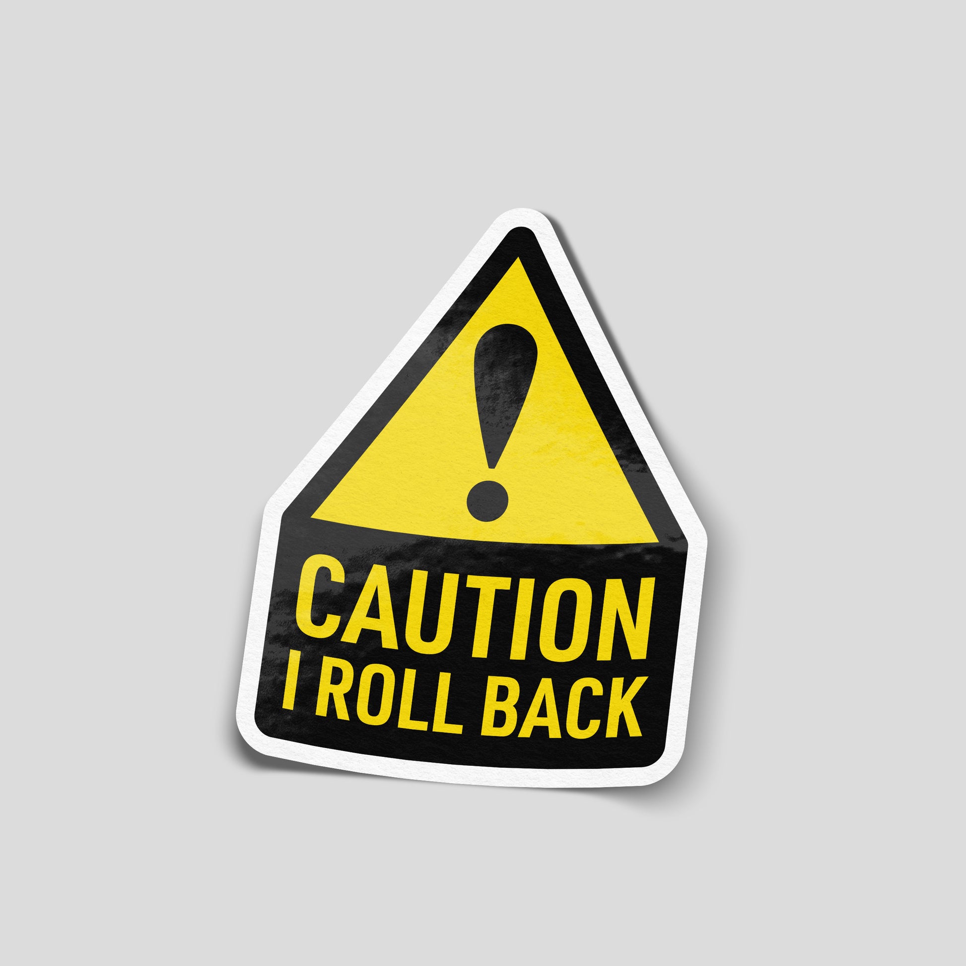 Yellow and black warning‑style funny car sticker reading “Caution, I roll back”, UK driving humour decal.