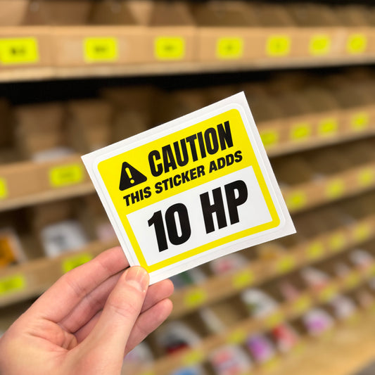 Funny car sticker reading “this sticker adds 10 HP” gaming style warning design