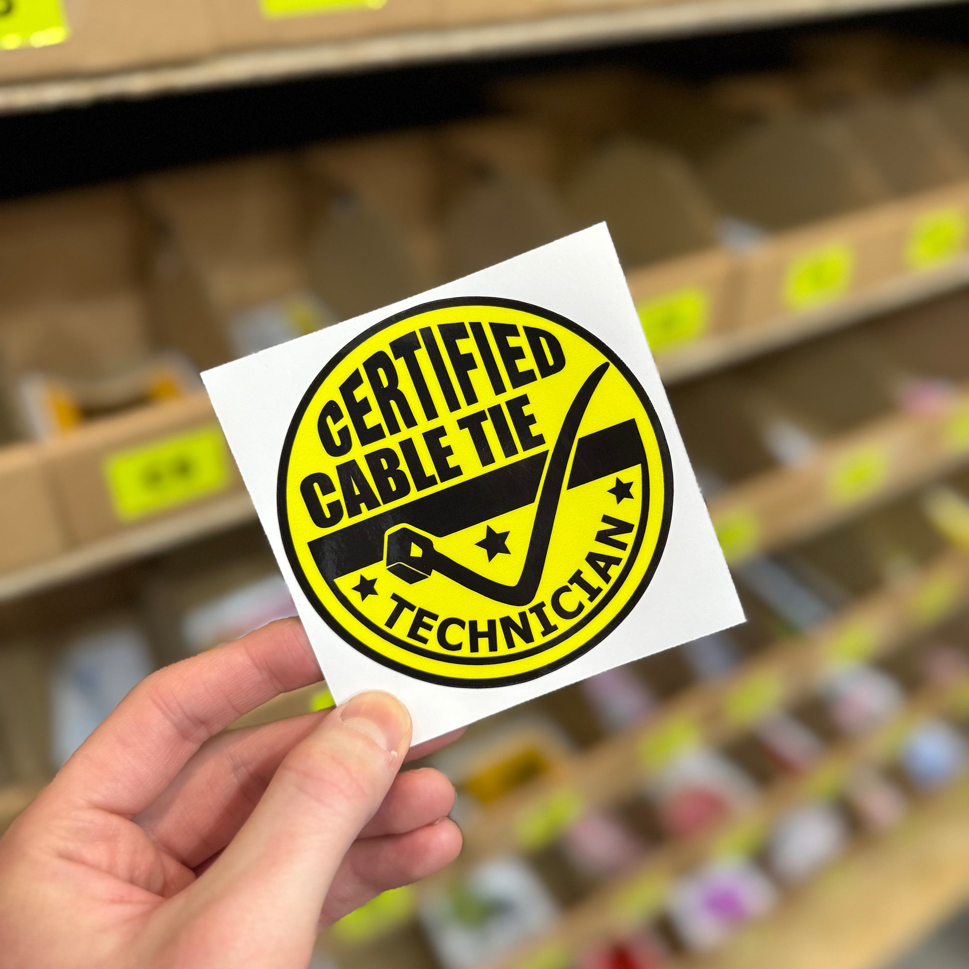 Funny trades sticker reading “certified cable tie technician” with tool graphic
