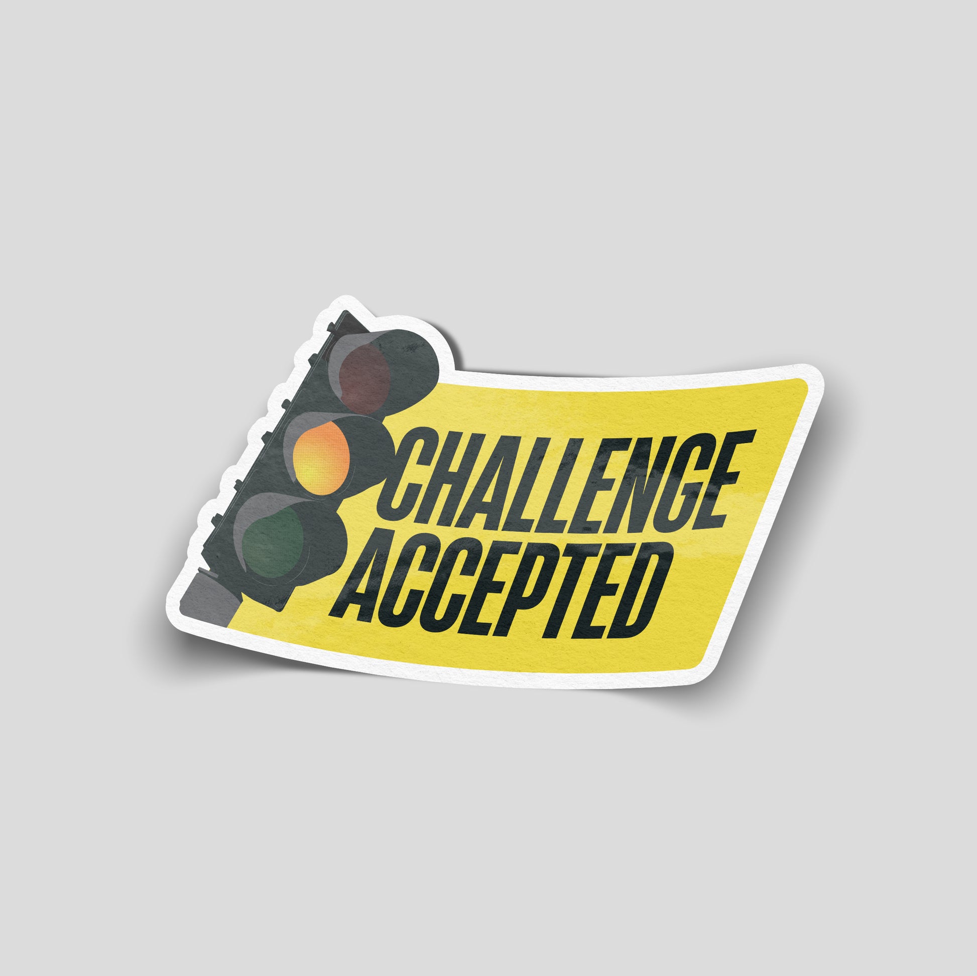 Yellow funny car sticker showing a traffic light next to the text “Challenge Accepted”, UK motoring humour decal.