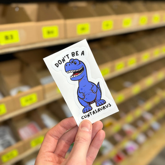 Funny dinosaur sticker reading “don’t be a cuntasaurus” rude novelty design