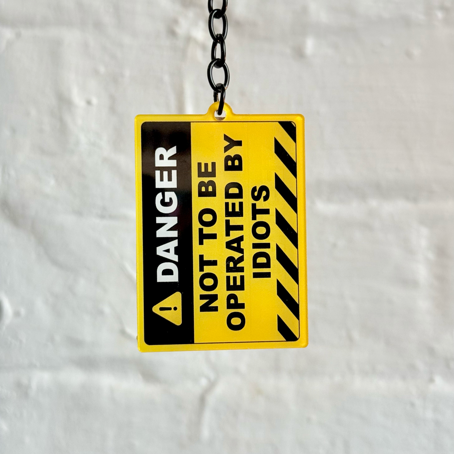 Danger not to be operated by idiots funny warning sign acrylic keychain with black chain