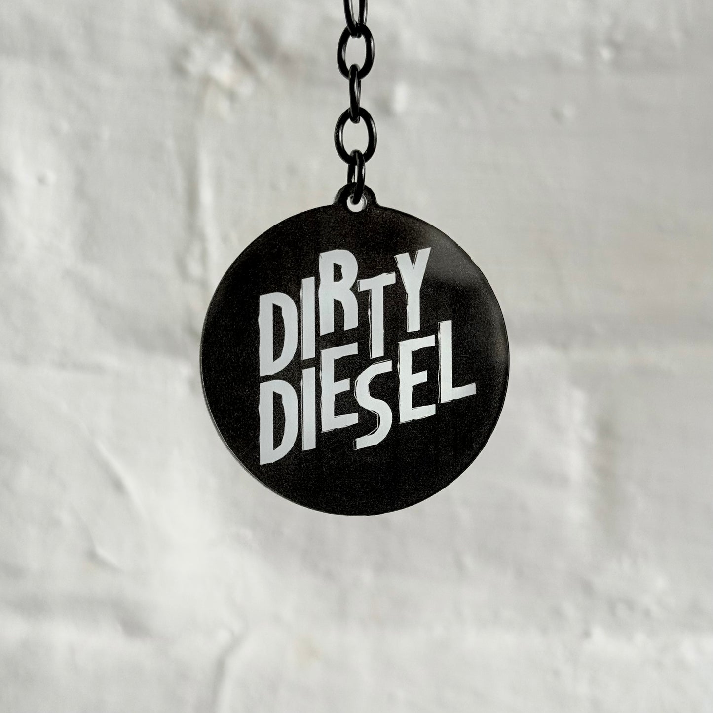 Funny “Dirty Diesel” acrylic keychain with bold black and white design, glossy double-sided print and black chain, ideal for diesel car and truck owners.