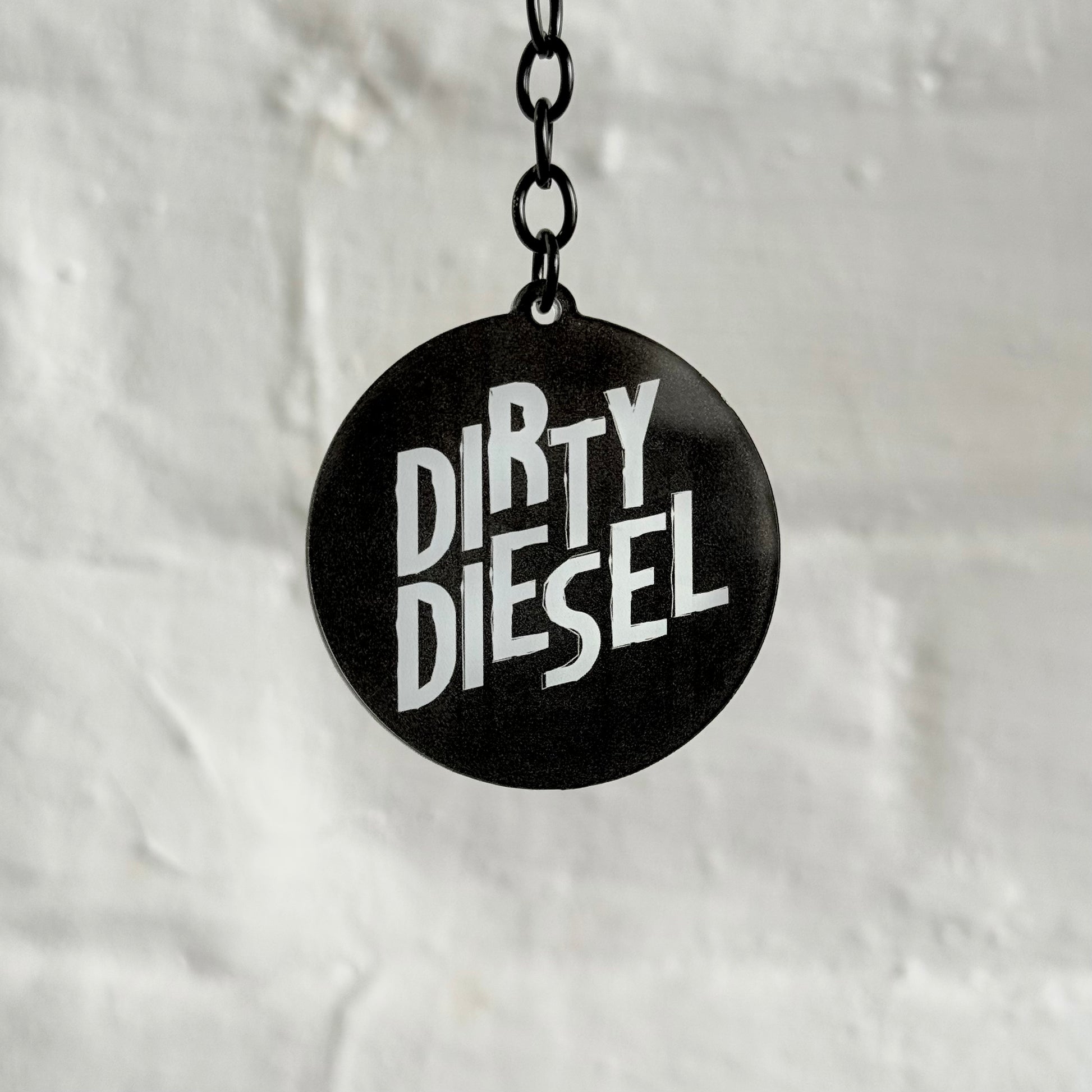 Funny “Dirty Diesel” acrylic keychain with bold black and white design, glossy double-sided print and black chain, ideal for diesel car and truck owners.