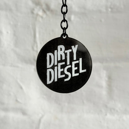 Funny “Dirty Diesel” acrylic keychain with bold black and white design, glossy double-sided print and black chain, ideal for diesel car and truck owners.