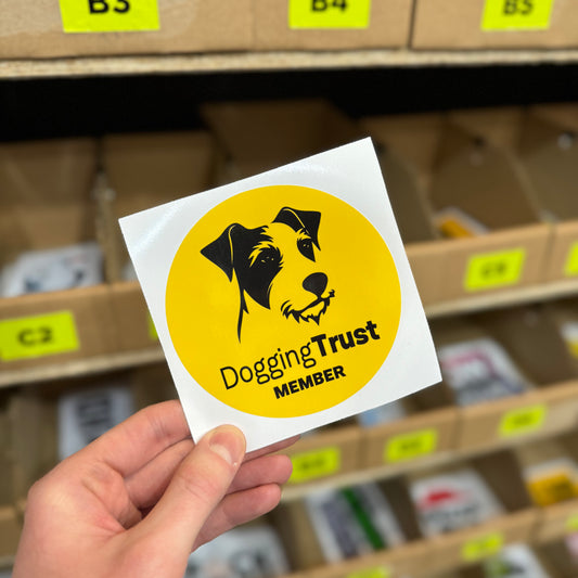 Funny parody sticker reading “dogging trust member” with dog illustration