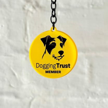 Funny “Dogging Trust Member” acrylic keychain with parody dog logo design, glossy finish and black chain, cheeky novelty car keyring gift.