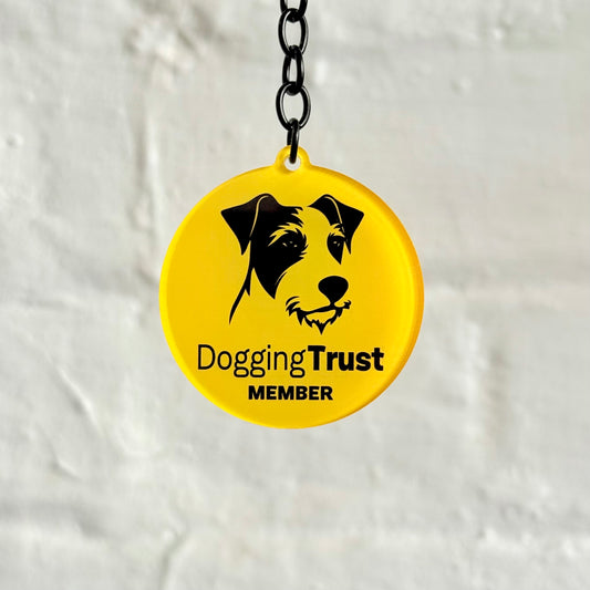 Funny “Dogging Trust Member” acrylic keychain with parody dog logo design, glossy finish and black chain, cheeky novelty car keyring gift.