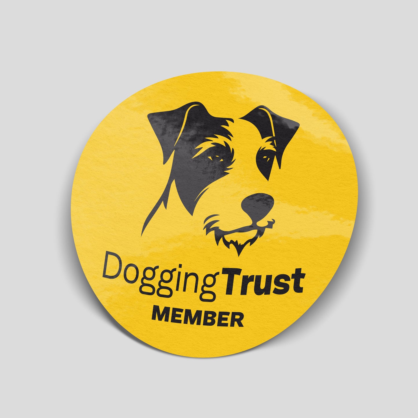 Yellow circular “Dogging Trust Member” funny car sticker with black dog illustration, UK parody humour decal.