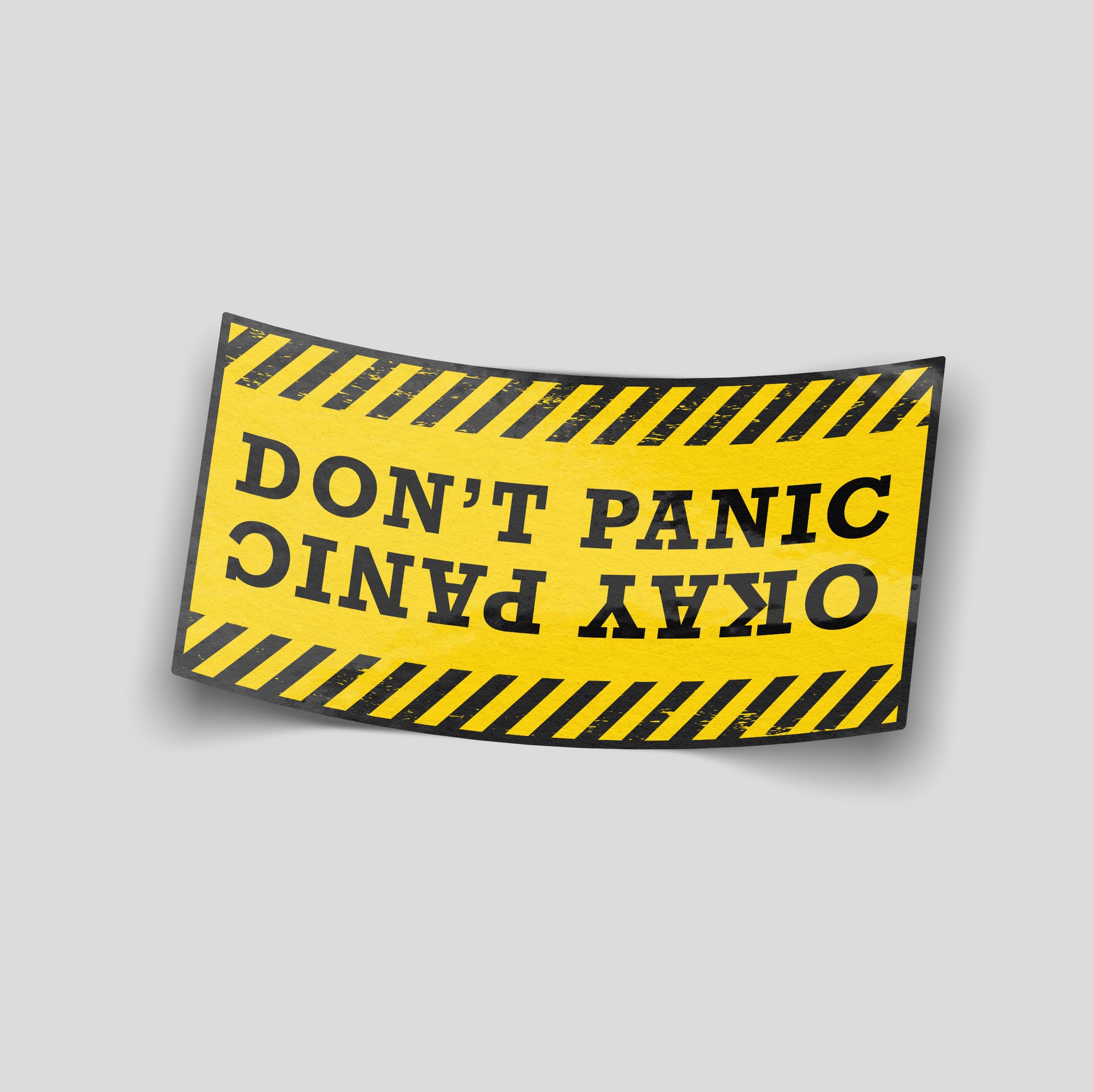 Yellow hazard‑style funny car sticker with alternating “Don’t Panic / Okay Panic” text, bold UK motoring humour decal.
