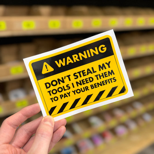 Funny trades sticker reading “don’t steal my tools I need them to pay your benefits” warning sign style