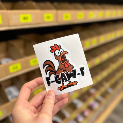 F-CAW-F funny vinyl car sticker with angry cartoon chicken illustration, gloss laminated waterproof UK made novelty decal held in hand by Blum Decals.