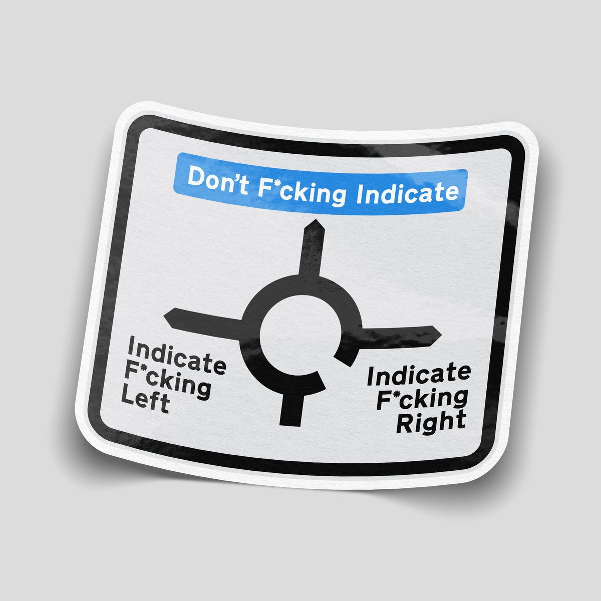 Roundabout sign sticker labelled “Don’t Fcking Indicate”, “Indicate Fcking Left” and “Indicate F*cking Right”.